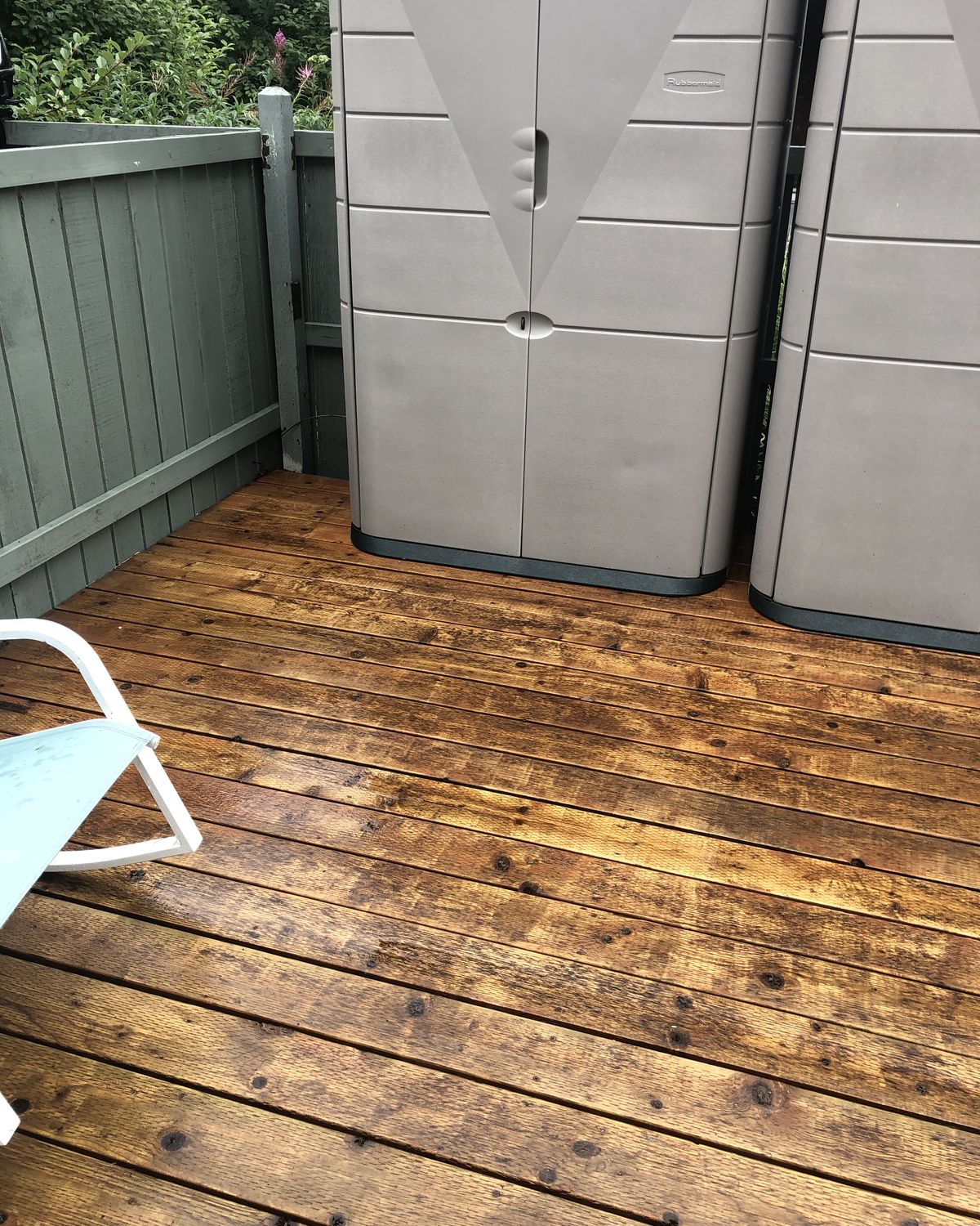The same deck washed back to bare wood, the storage cabinets clean