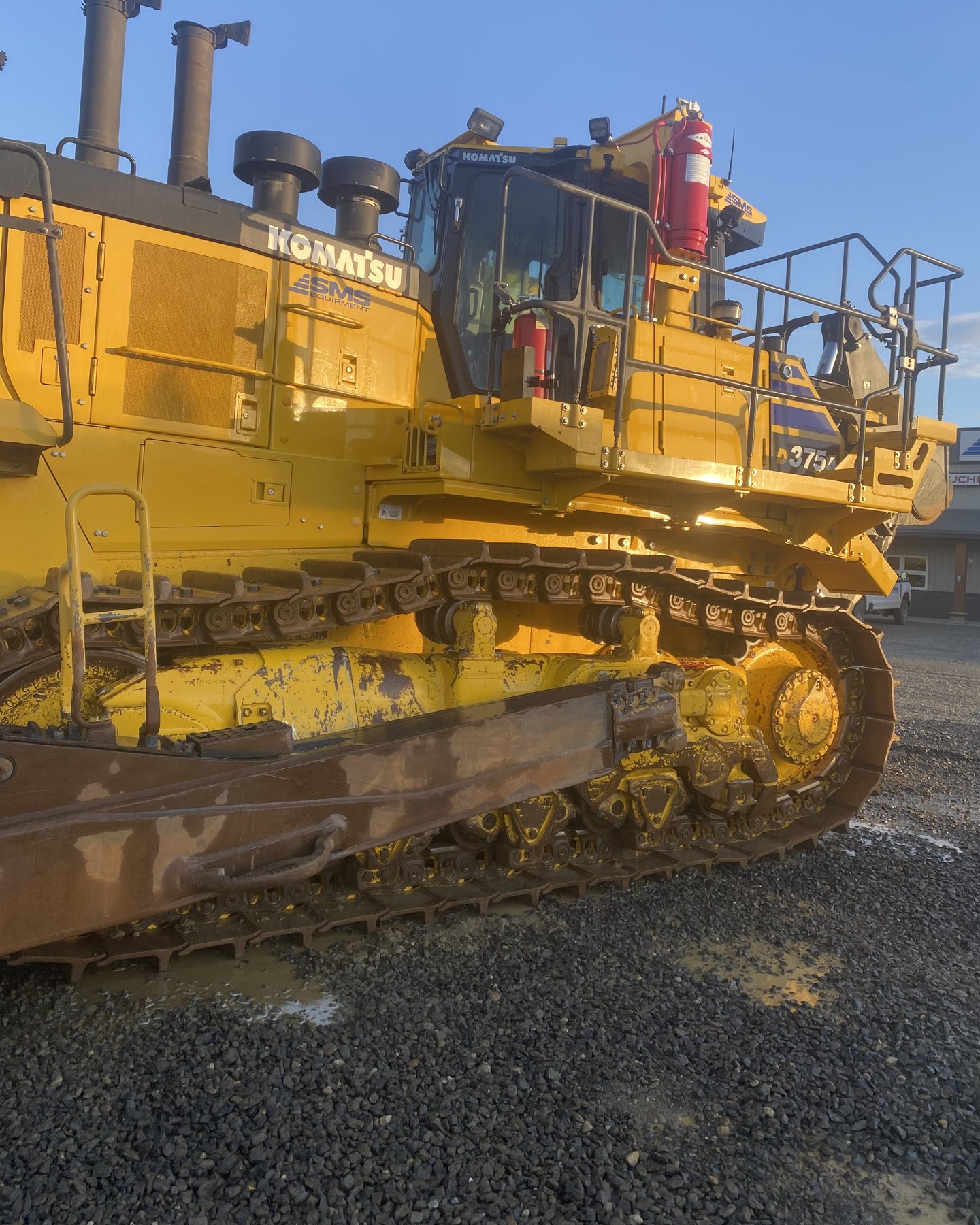 A Komatsu D375A bulldozer with its tracks and rollers washed back to yellow