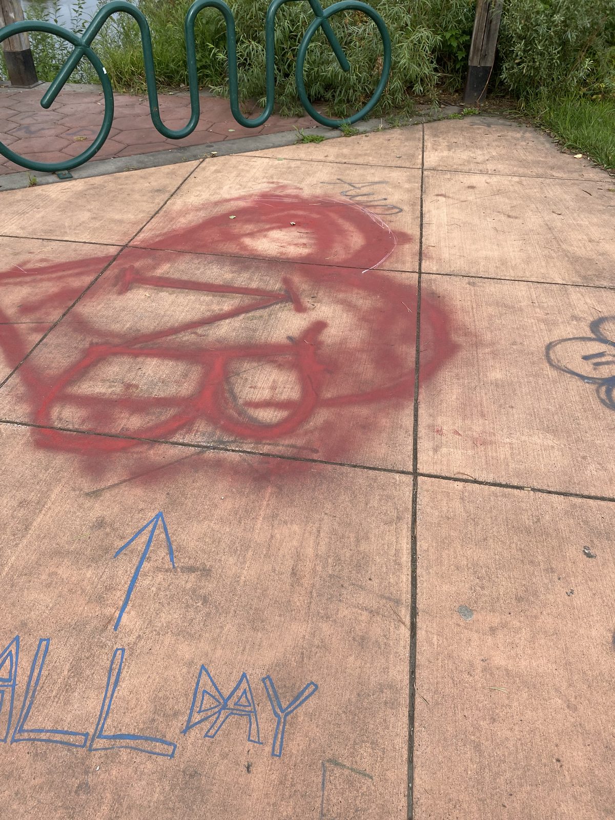 Red and blue spray paint tags across the pavers at Golden Heart Plaza in downtown Fairbanks